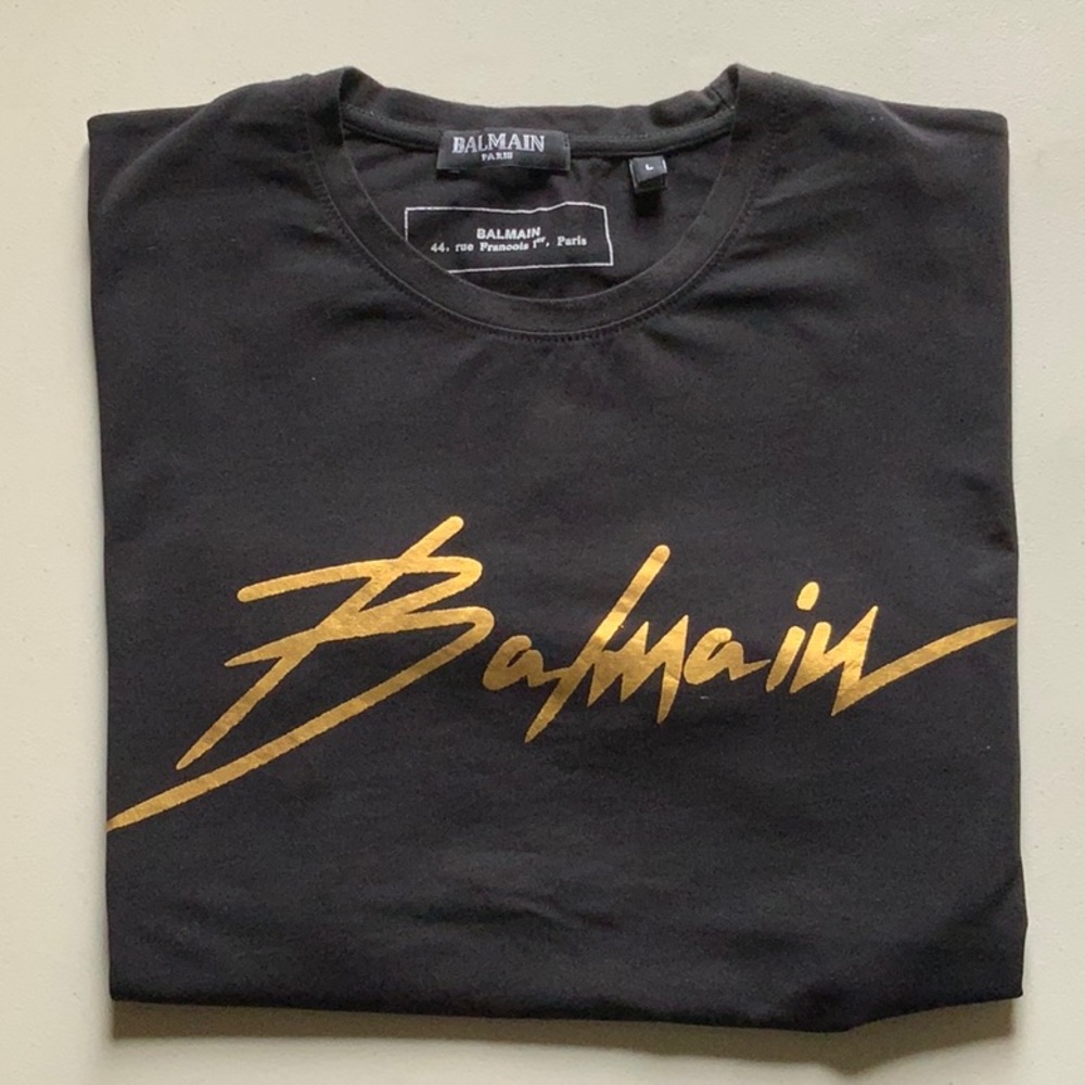 striking BALMAIN black with gold logo tee